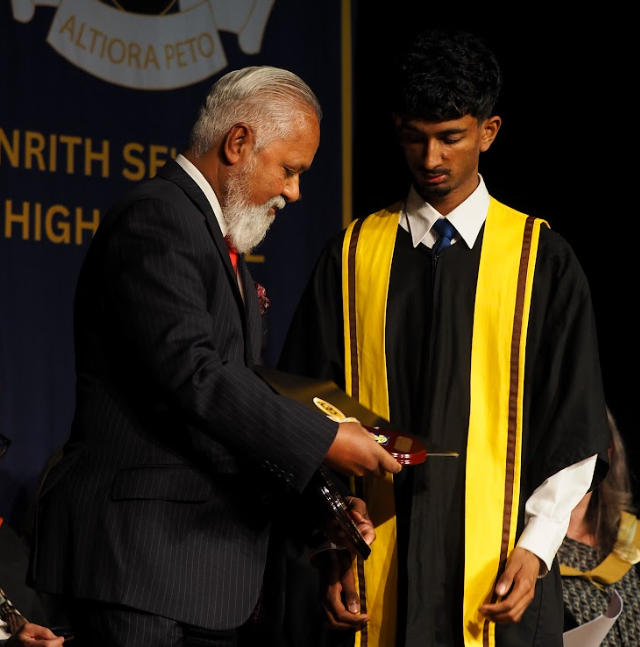 Photo of student being presented award