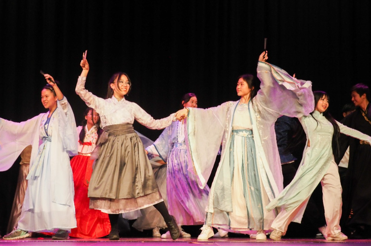 Students performing in cultural dress at a school event