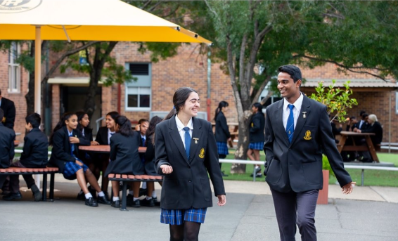 Two students walking through the playground