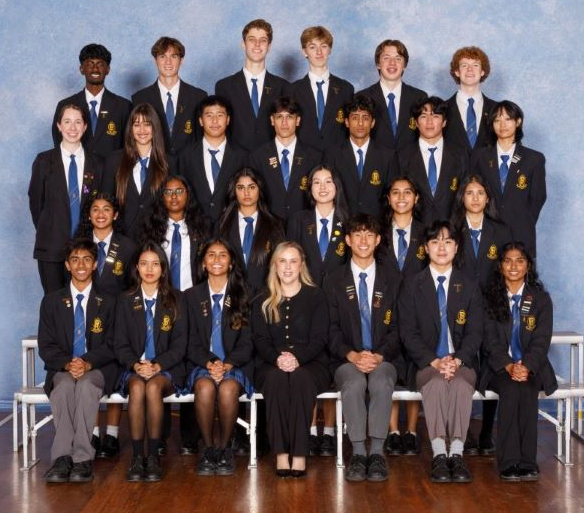 School principal surrounded by student leaders